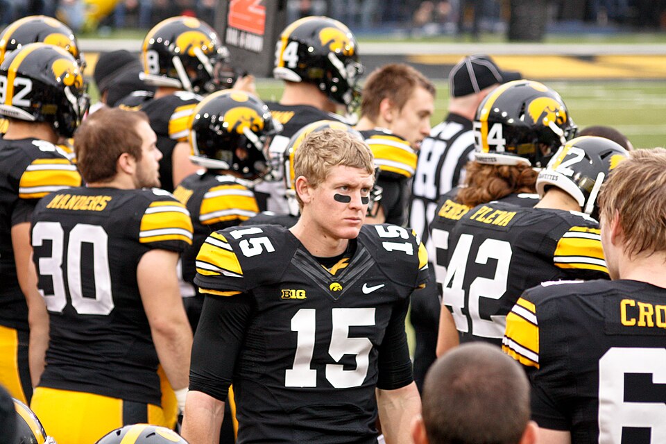 College quarterback looking downfield along the sideline