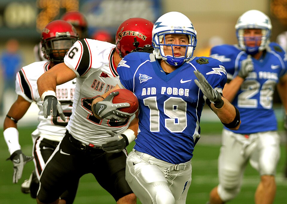 Receiver running with the ball as the defense closes in